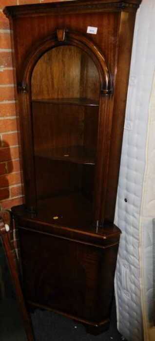 A walnut standing corner cabinet, the open top with two shelves above a door, 65cm wide.