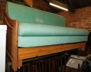 A pine framed double sofa bed. 
The upholstery in this lot does not comply with the 1988 (Fire &...