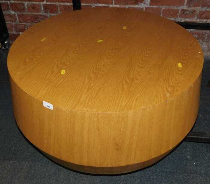 A light oak circular coffee table, 36cm high, 77cm diameter.
