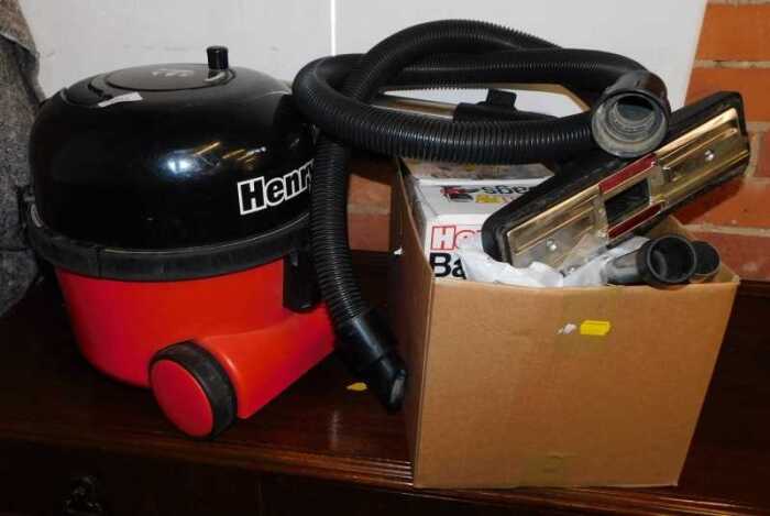 A Henry vacuum cleaner, with accessories.