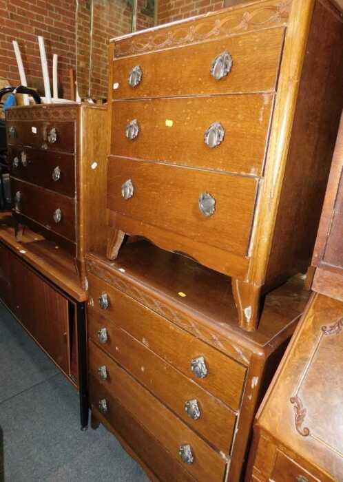 A Lebus Furniture oak bedroom suite, comprising mirror back three drawer chest, a four drawer...