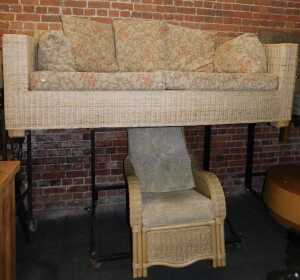 A cane three seater settee and matching armchair. (2) The upholstery in this lot does not comply...