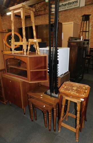 A group of furniture, to include a teak Singer sewing machine cabinet and sewing machine,...
