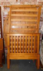 A pine single bed, comprising headboard, footboard and base, and a pine kingsize bedhead.