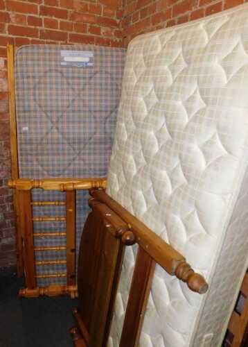A pine single bed, comprising headboard, footboard, base and mattress, and another.