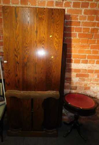 An oak dining table, together with a drum top occasional table inset with a tooled red leather...