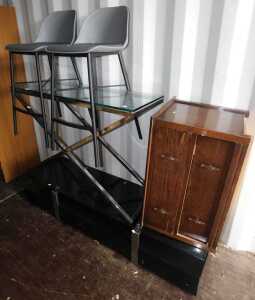 A black glass television stand, together with a glass top side table, on metal X frame base,...