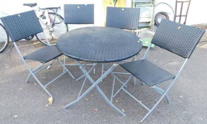 A folding garden table with a woven plastic top, together with four folding chairs, a deck chair,...