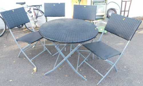 A folding garden table with a woven plastic top, together with four folding chairs, a deck chair,...