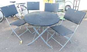 A folding garden table with a woven plastic top, together with four folding chairs, a deck chair,...