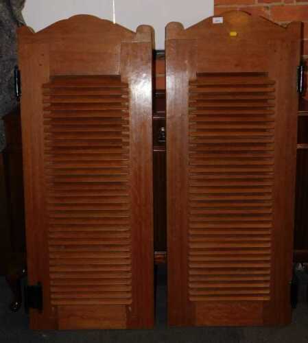 A pair of teak saloon doors, with louvred fronts, 131cm high, each 52cm wide.