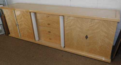 An Italian birdseye maple side cabinet, having a rectangular top with silvered metallic...