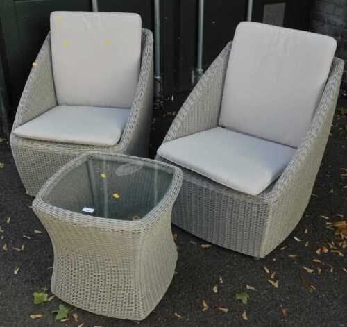 Two wicker garden chairs, with loose seat cushions, together with a matching hourglass shaped...