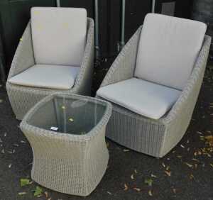 Two wicker garden chairs, with loose seat cushions, together with a matching hourglass shaped...