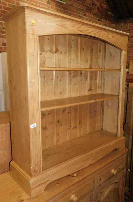 A pine open bookcase, 110cm high, 104cm wide, 29cm deep.