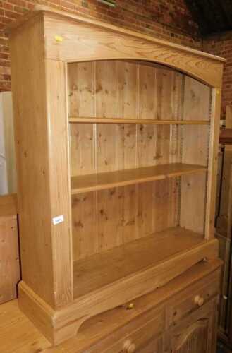 A pine open bookcase, 110cm high, 104cm wide, 29cm deep.
