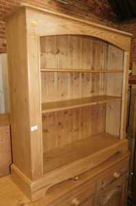 A pine open bookcase, 110cm high, 104cm wide, 29cm deep.