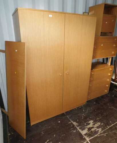 A 1970s Avalon teak bedroom suite, comprising double wardrobe, headboard, chest of four drawers,...