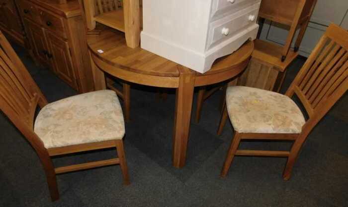 A contemporary oak kitchen table, circular top raised on square legs, 74cm high, the top 92cm...
