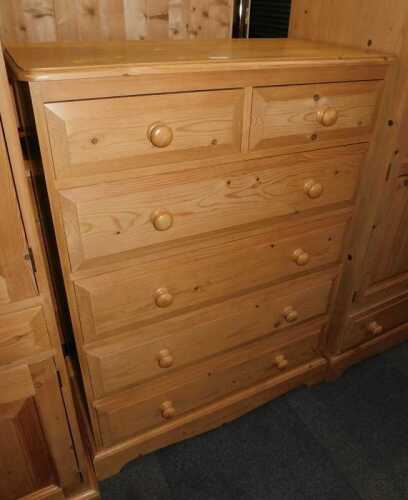 A contemporary pine chest, of two short over four long drawers, raised on bracket feet, 118cm...