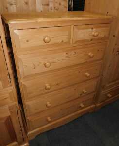 A contemporary pine chest, of two short over four long drawers, raised on bracket feet, 118cm...