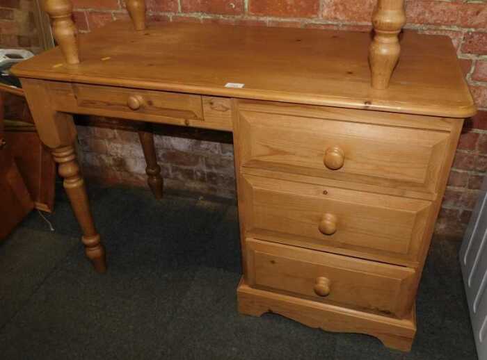 A contemporary pine dressing table, with an arrangement of four drawers, raised on bracket and...