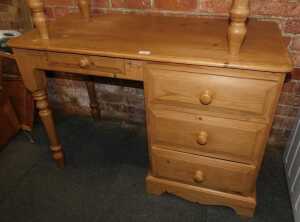 A contemporary pine dressing table, with an arrangement of four drawers, raised on bracket and...