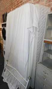 A single bed, comprising metal headboard, mattress and divan bed base.