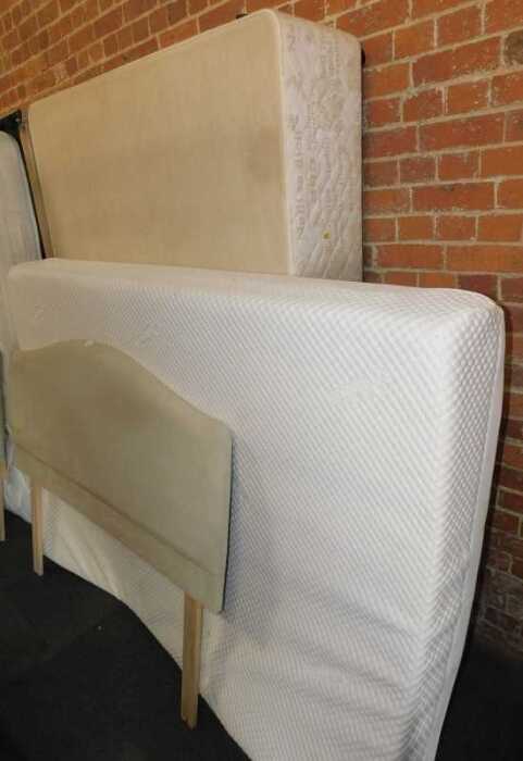 A double bed, comprising upholstered headboard, mattress, and bed base.