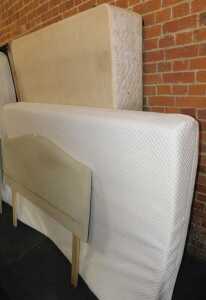 A double bed, comprising upholstered headboard, mattress, and bed base.