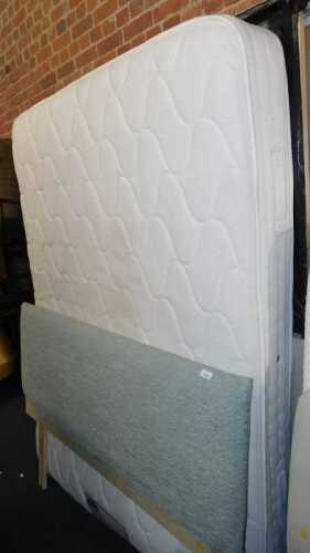 A double bed, comprising upholstered headboard, mattress and bed base.