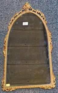 A gilt metal arched wall mirror, 70cm high.
