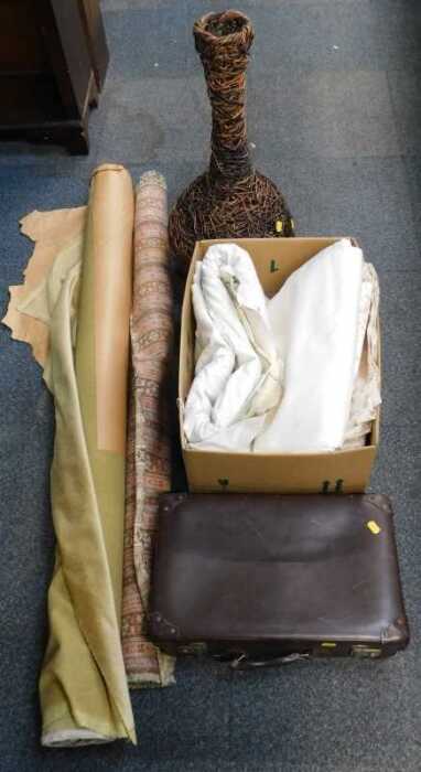 Upholstery and curtain material, a wicker vase, and a brown leather suitcase.
