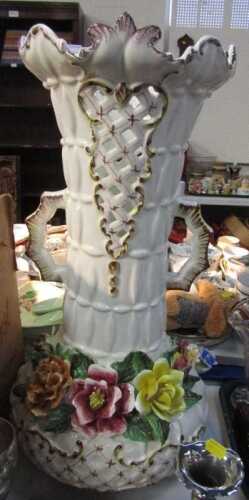 A Continental pottery twin handled floor standing vase, with an elongated pierced neck and squat...