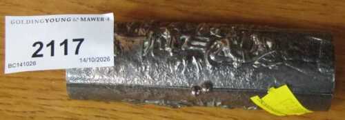A silver plated cylindrical box, possibly for lipstick, embossed with scenes depicting figures,...