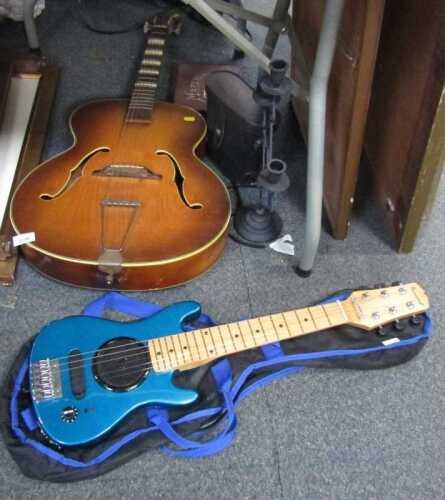 An archtop acoustic guitar, together with a Burswood child's electric guitar, cased, cased...