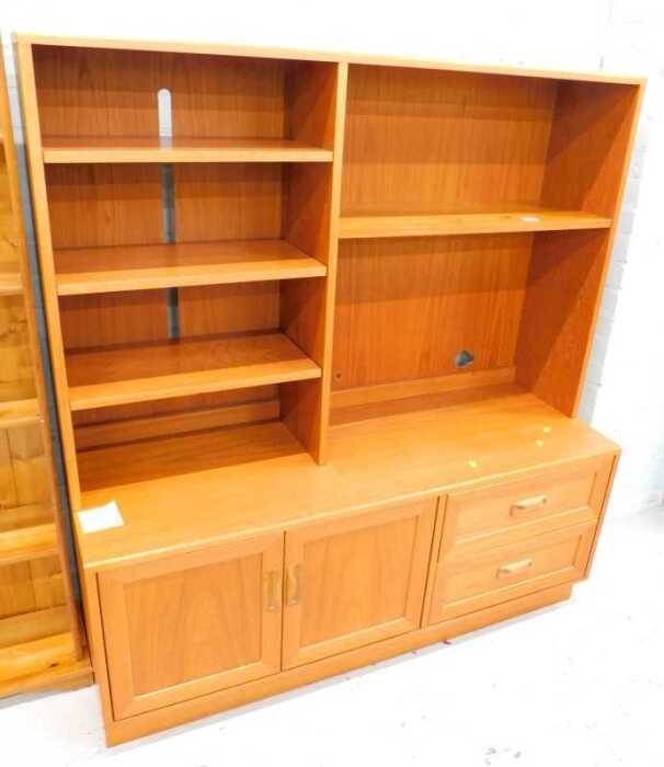 A 1970s G-Plan teak open cabinet, with shelves above double cupboards and drawers beneath, 143cm...