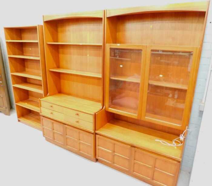 A Nathan teak display unit, comprising open shelves and glazed shelves in two sections, and a...