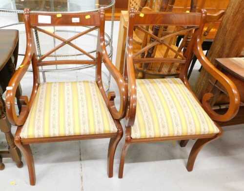 A pair of reproduction Regency carver chairs, with drop in seats, upholstered in striped...