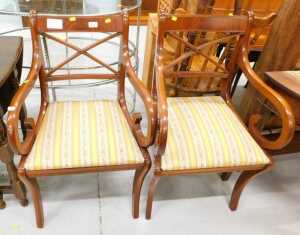A pair of reproduction Regency carver chairs, with drop in seats, upholstered in striped...