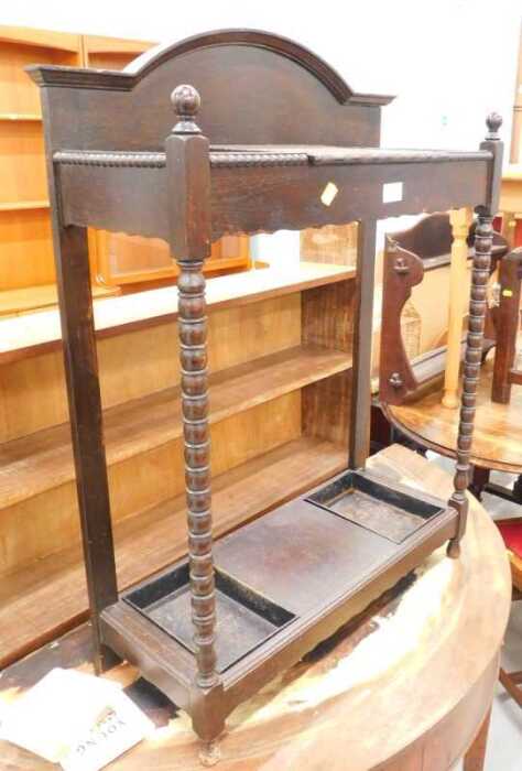 An Edwardian oak hall stand, with glove box, umbrella compartments and removable metal pans, on...