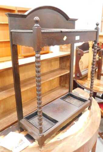 An Edwardian oak hall stand, with glove box, umbrella compartments and removable metal pans, on...