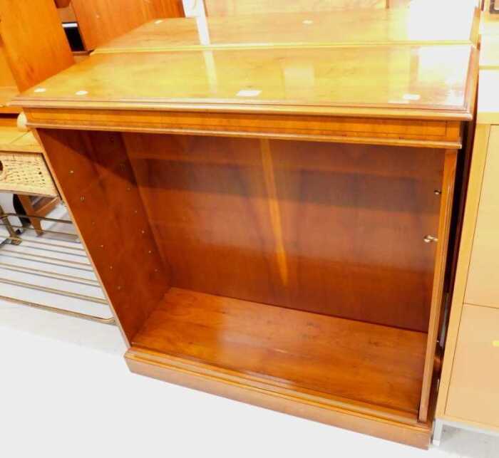 A pair of yew wood finish open bookshelves.