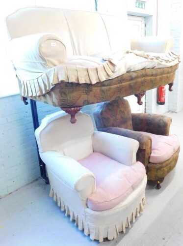 A three piece lounge suite, comprising three seater sofa and two armchairs, in floral and cream...
