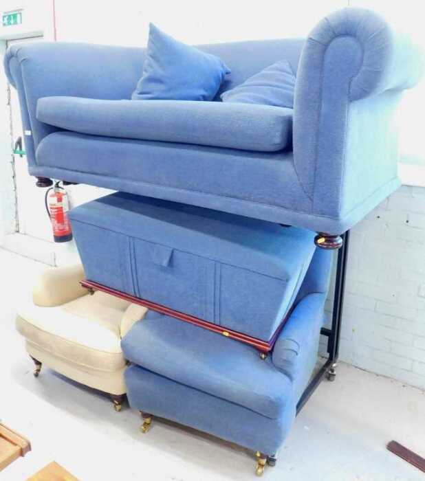 A three-piece lounge suite, comprising two seater Chesterfield sofa, single armchair and ottoman,...