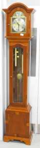 A Tempus Fugit yew wood finish Grandmother clock, with arched dial, raised spandrels, with...