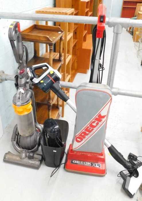 A Dyson upright vacuum cleaner, various other hand vacs, part paper shredder, and a commercial...