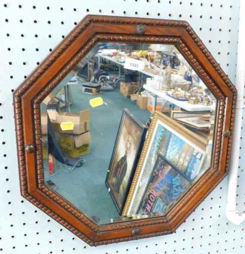 An oak framed octagonal mirror.