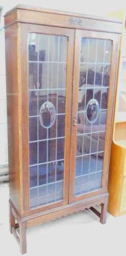 A 1930s oak freestanding bookcase, with lead glass doors.