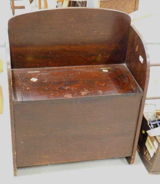 An oak single monk's seat, with log box, and various lightbulbs.